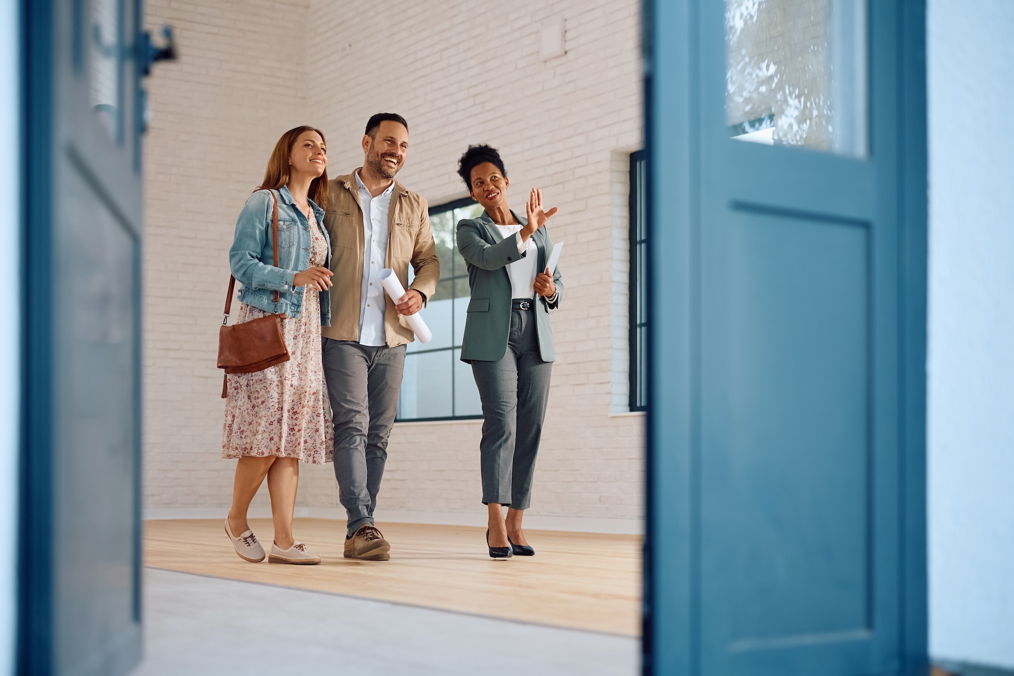Man and women on tour of building with another women
